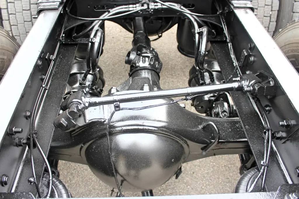 2021 Freightliner Cascadia 126 — underside view of rear drive axle housing, driveshaft and air springs between frame rails.